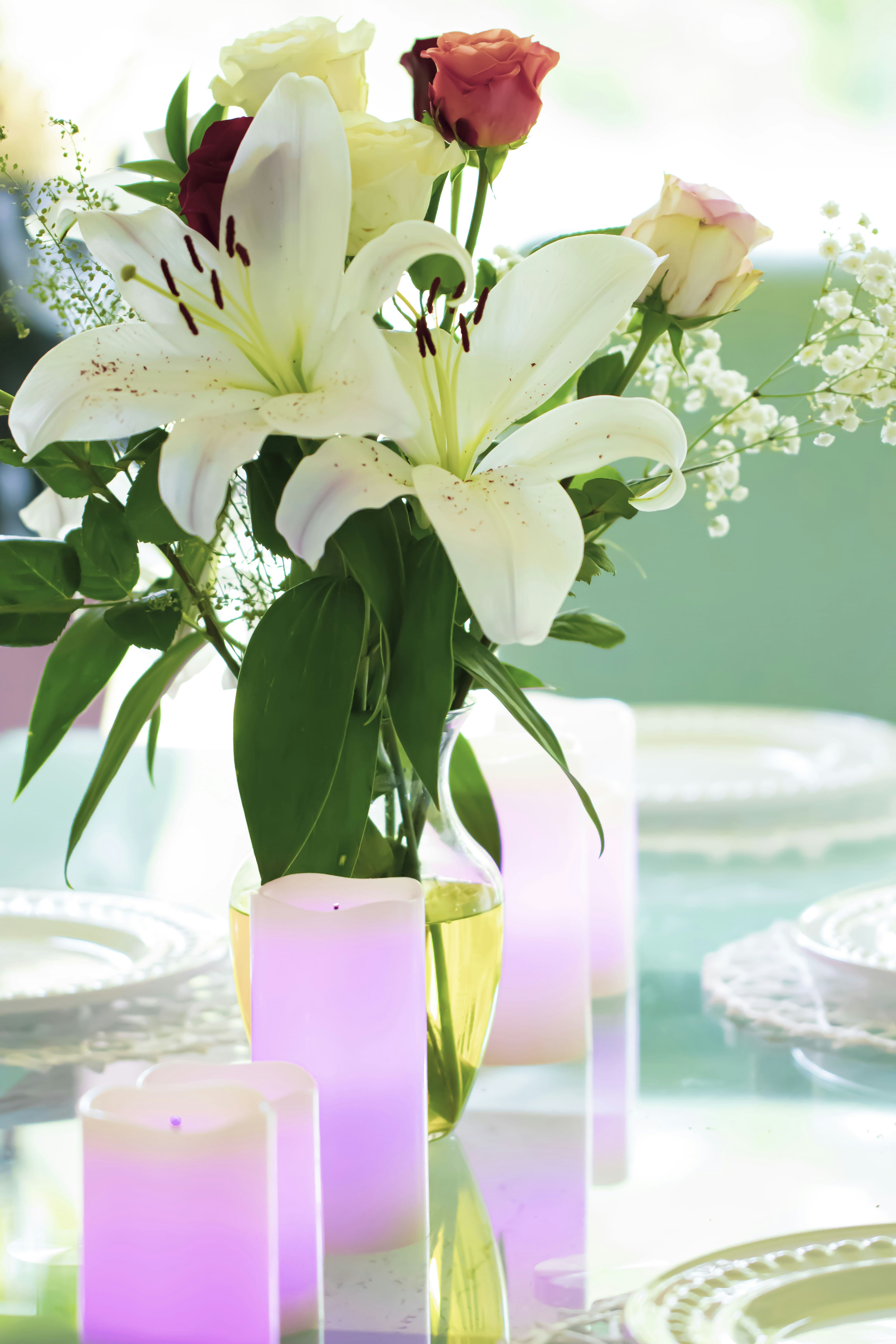 a vase filled with white and pink flowers on top of a table