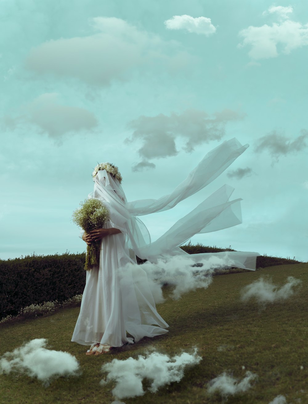 a woman in a white dress standing in a field