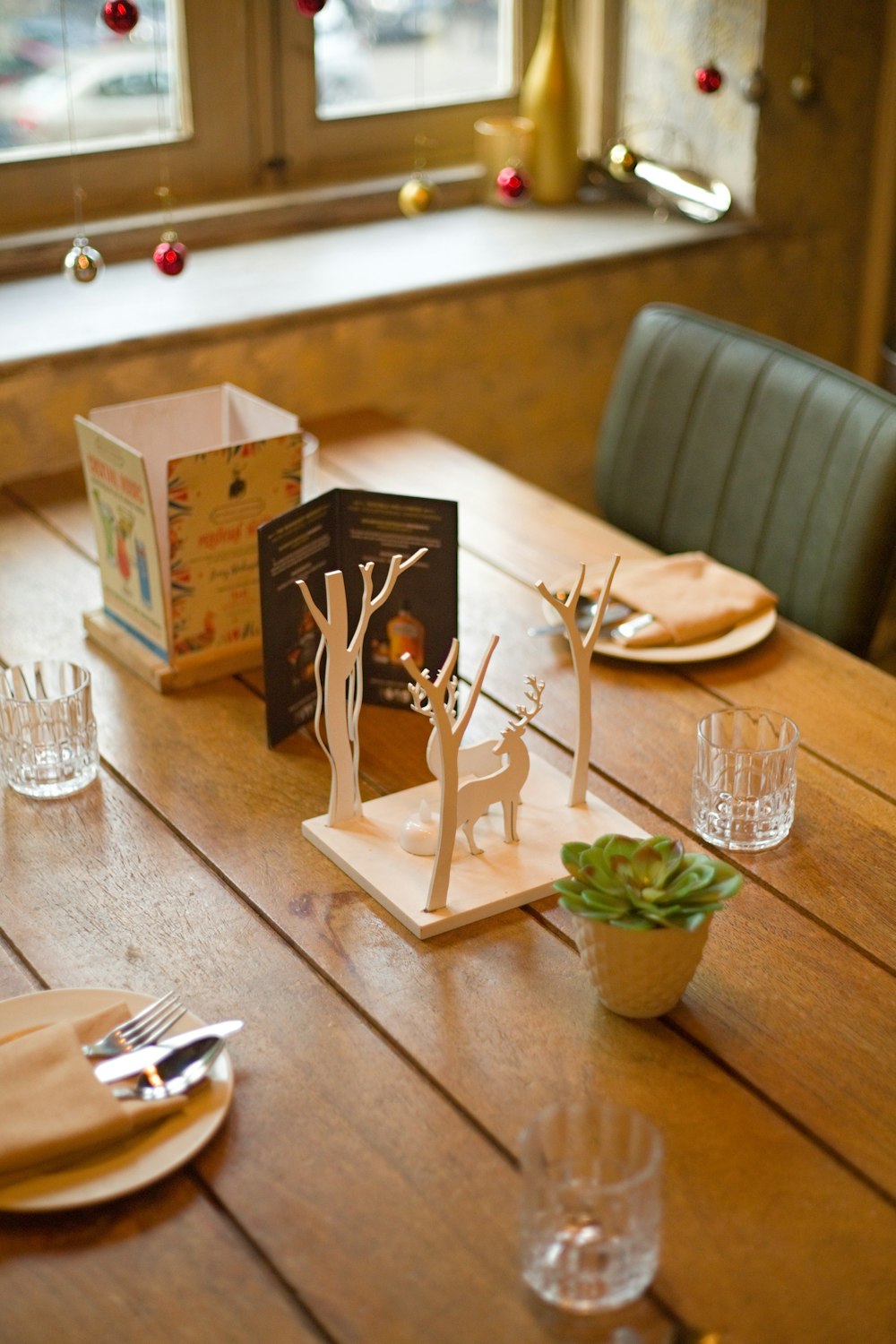 a wooden table topped with plates and glasses