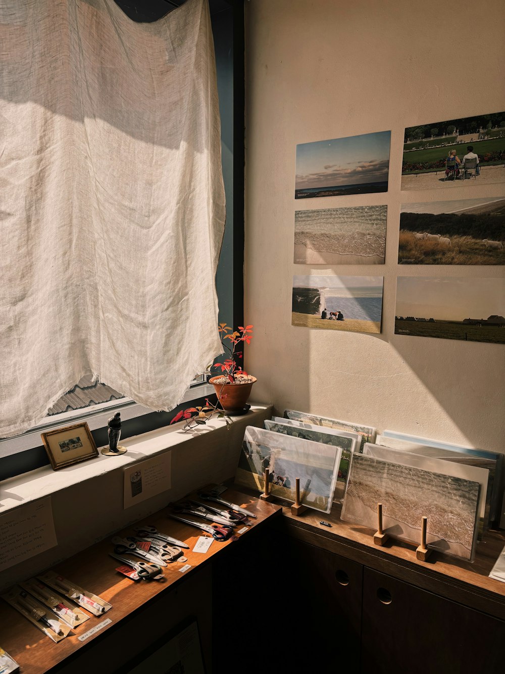 a room with a desk and pictures on the wall