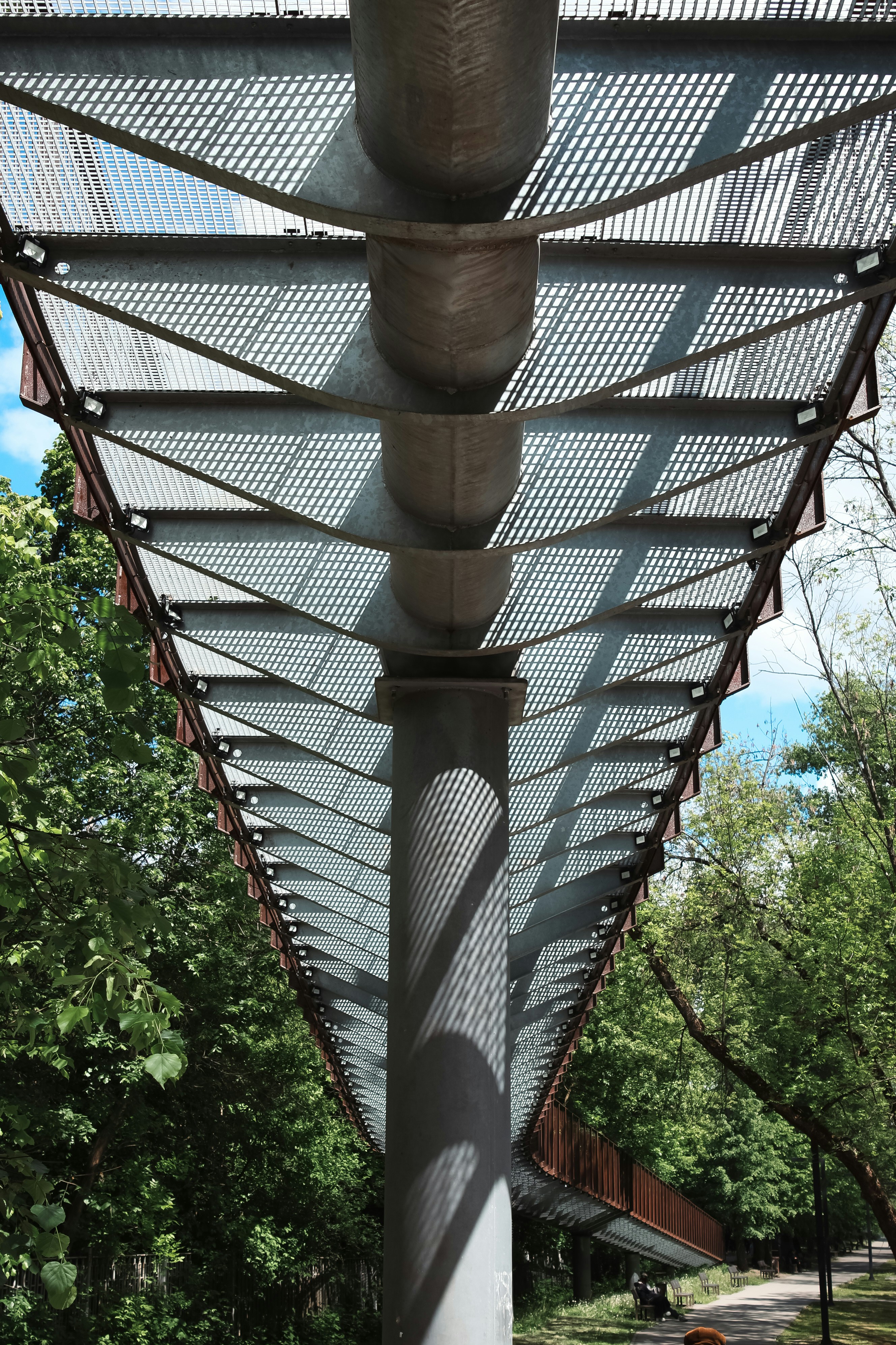 a metal structure with a bench underneath it