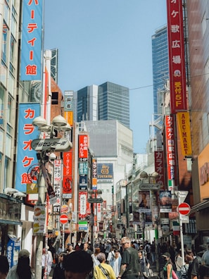 a crowded city street filled with lots of people