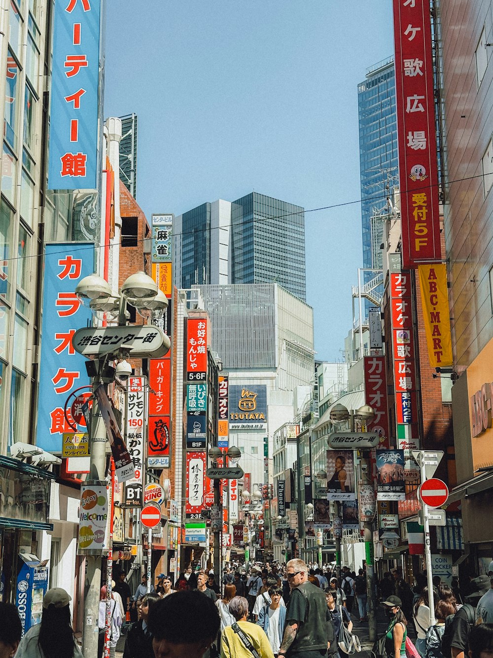 a crowded city street filled with lots of people