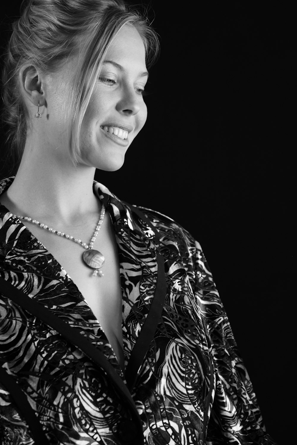 a black and white photo of a woman smiling