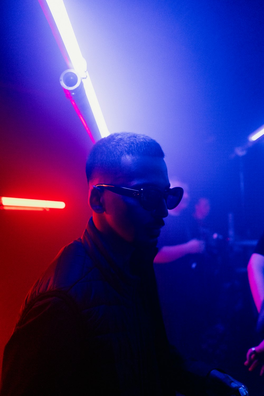a man in a dark room wearing sunglasses