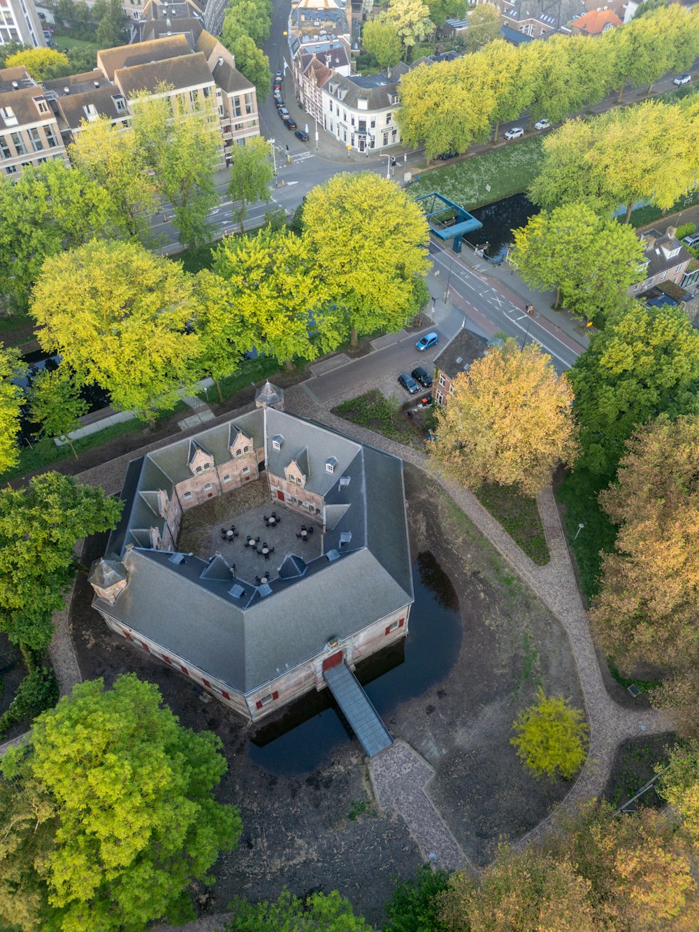 an aerial view of a building surrounded by trees