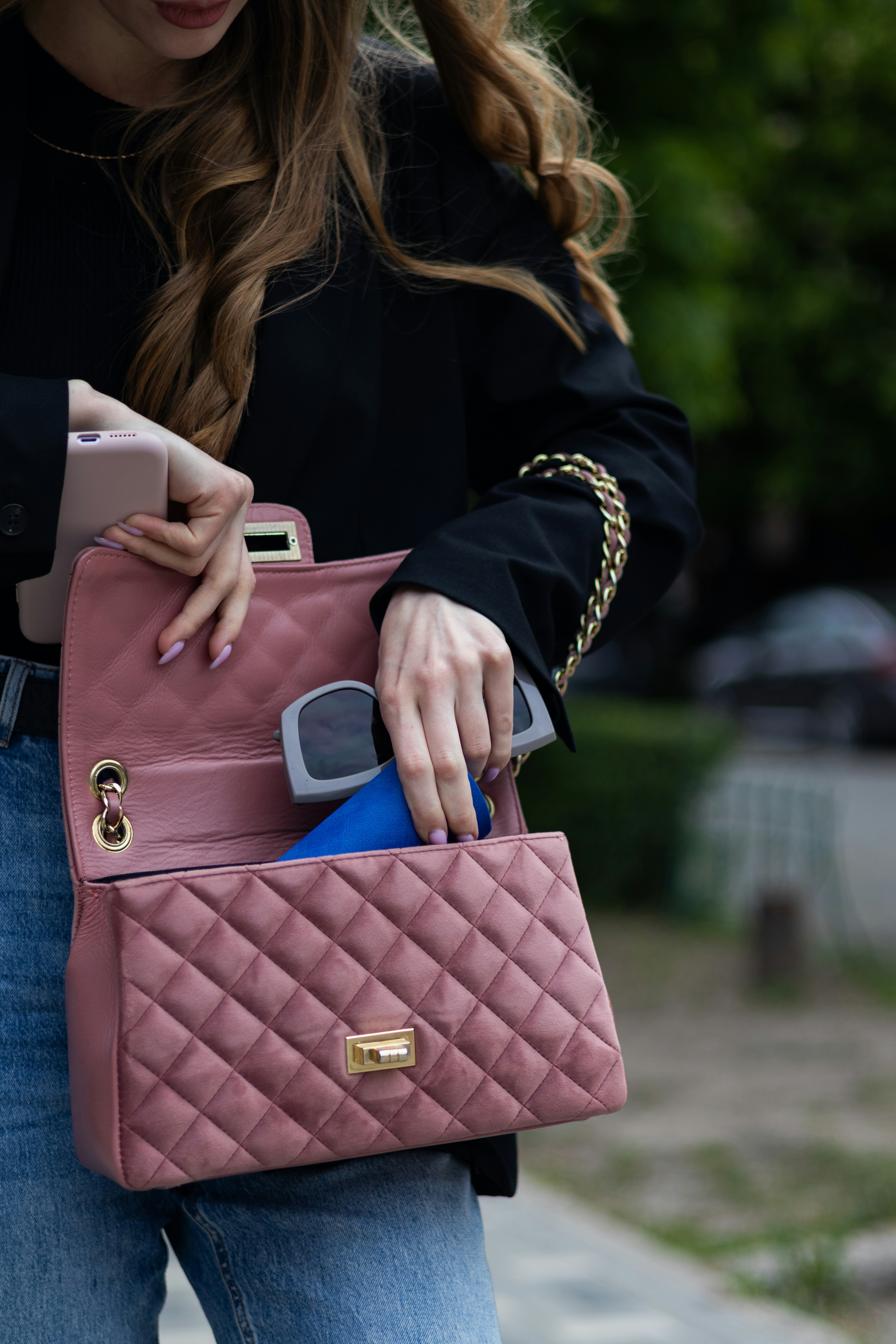 A Pink Purse And A Cell Phone