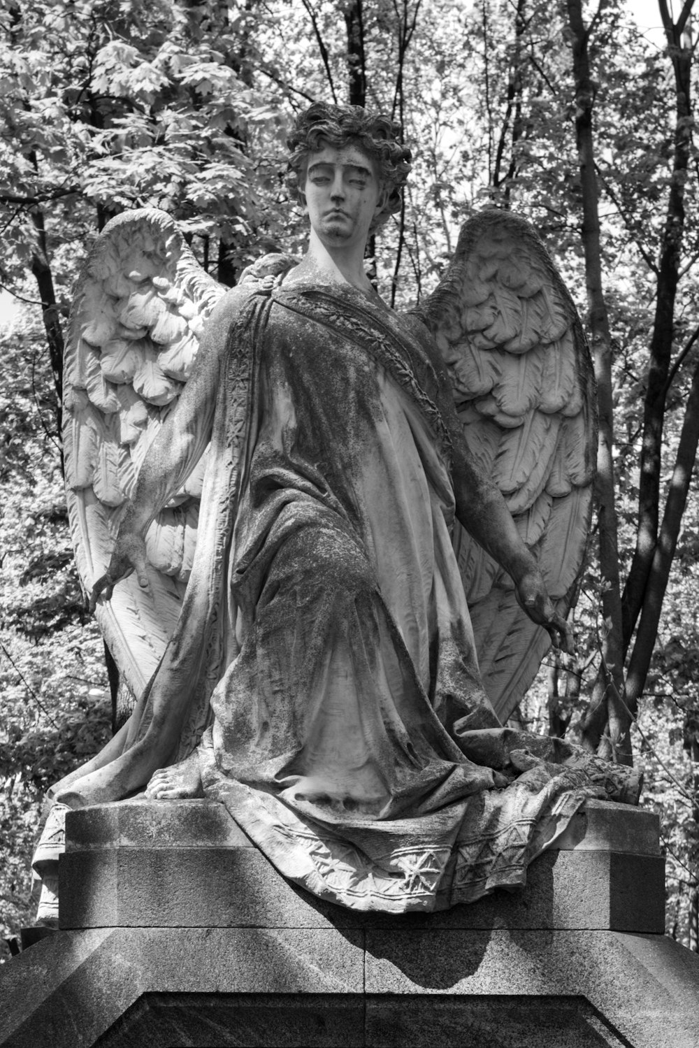 a black and white photo of an angel statue