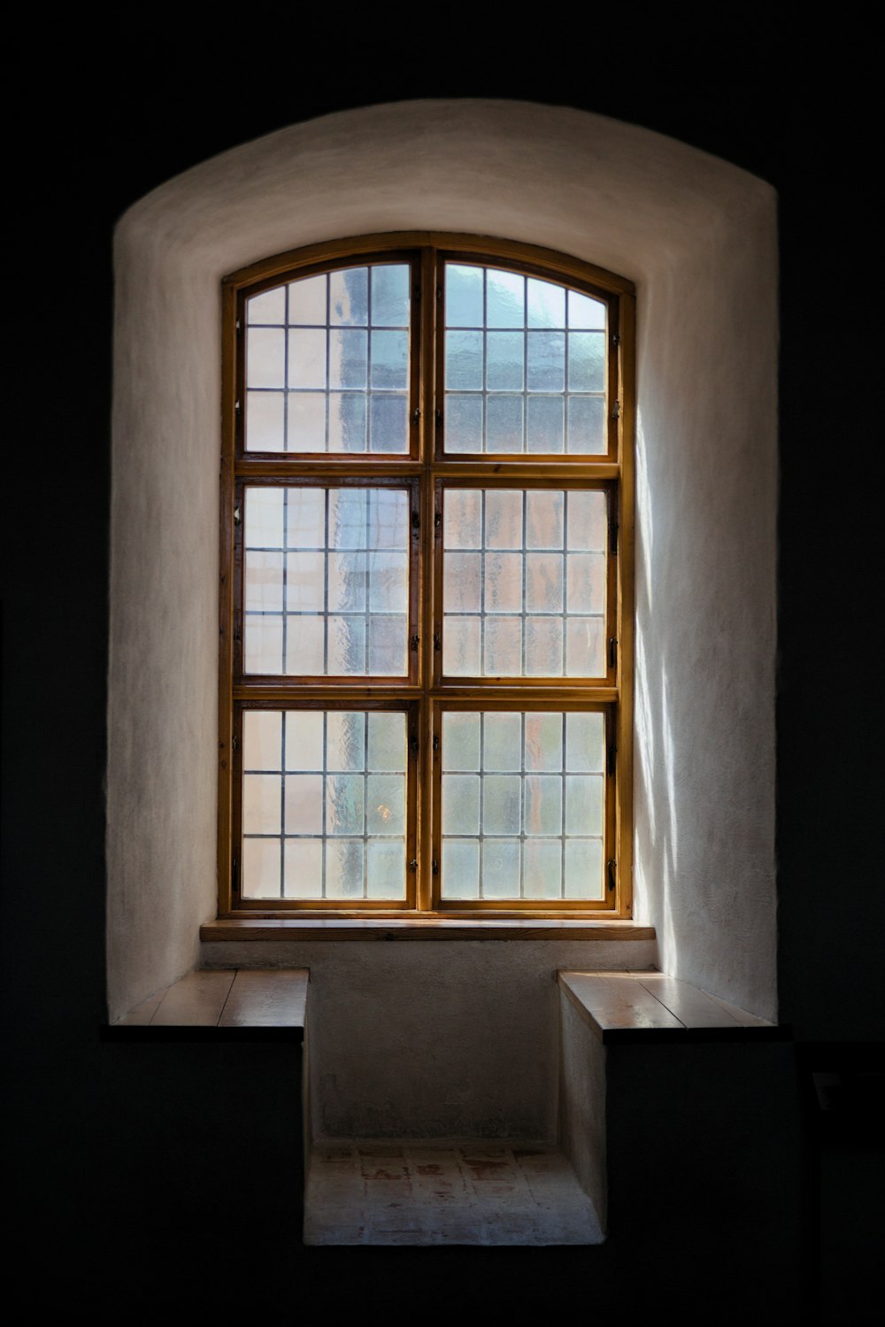 a window in a building with a light coming through it