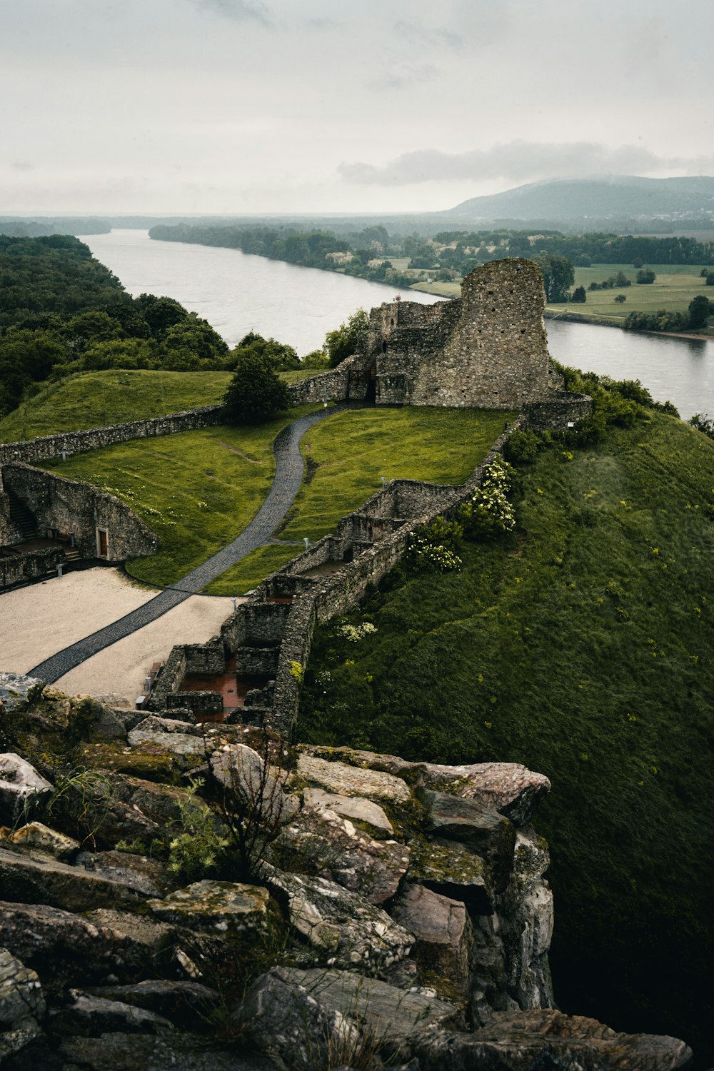 a castle on a hill overlooking a body of water