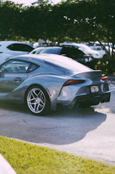 a silver sports car parked in a parking lot
