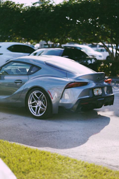 a silver sports car parked in a parking lot