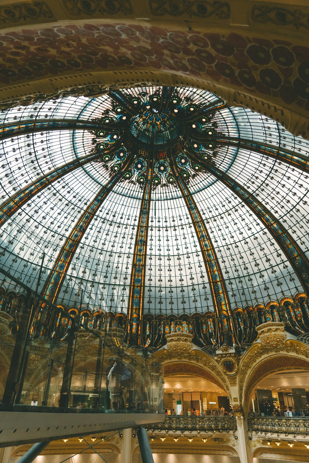 a large glass dome in a building with a chandelier