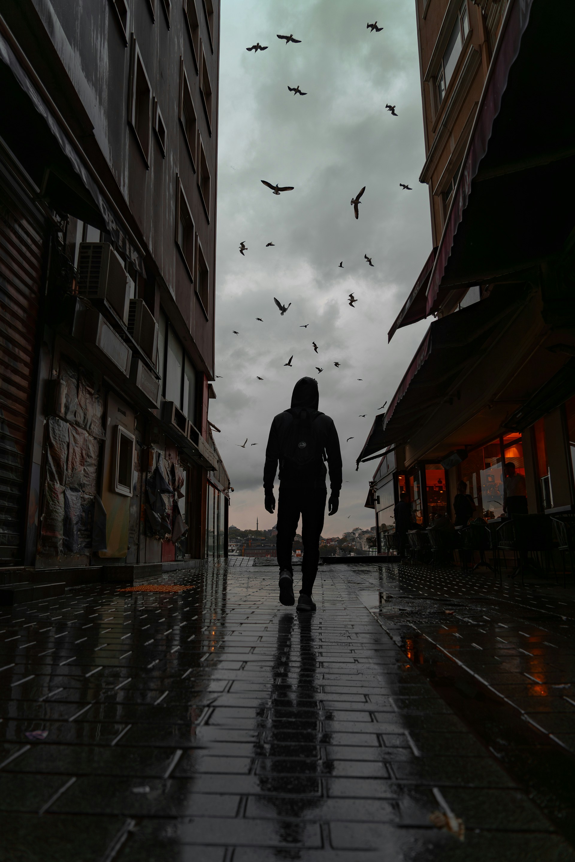a man walking down a street in the rain