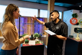 a woman pointing at a man in a black shirt