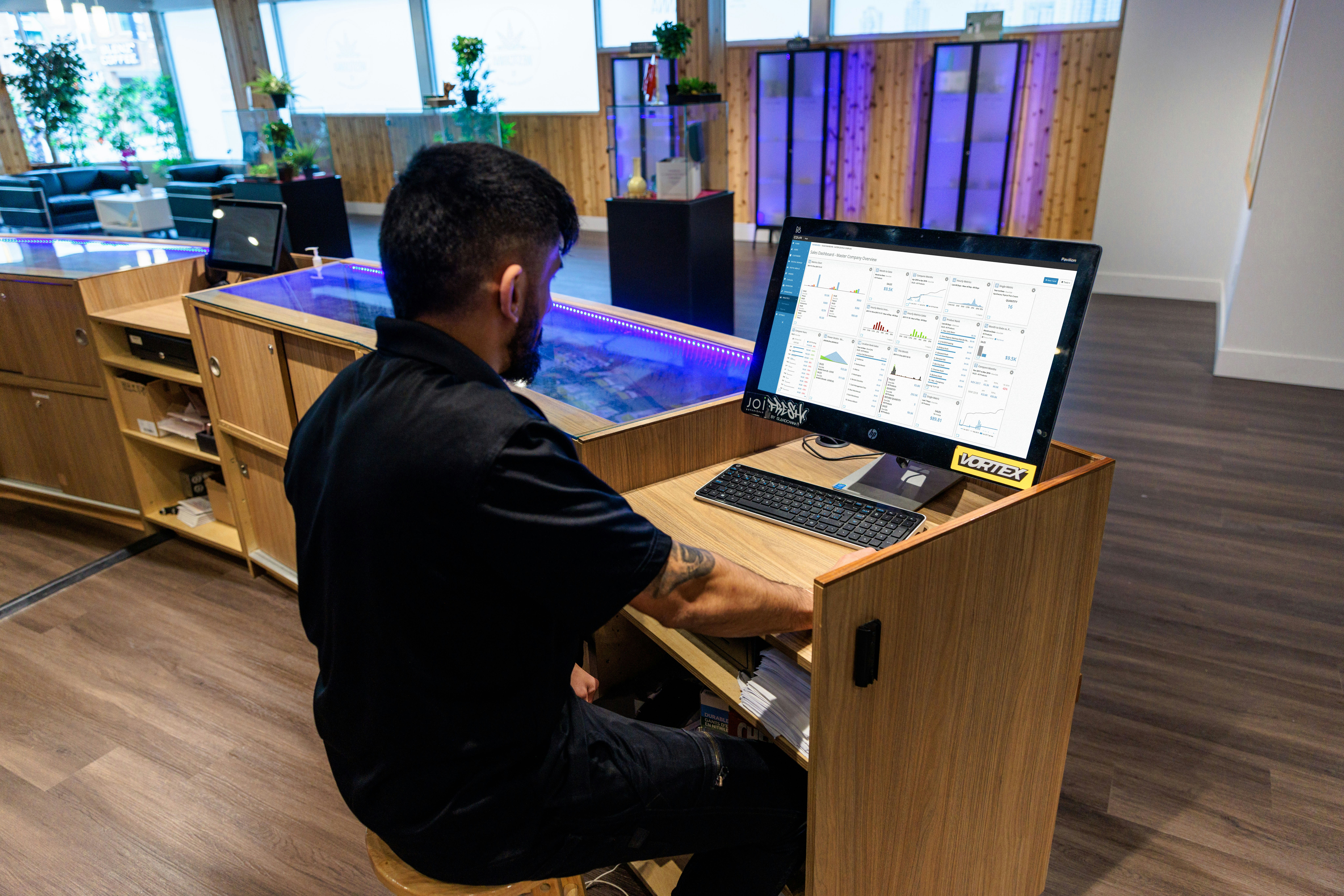 a man sitting at a desk using a computer