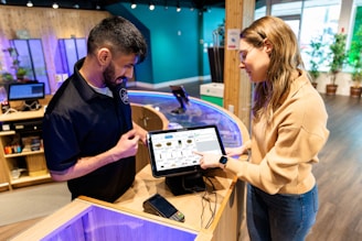 a man and a woman looking at a tablet