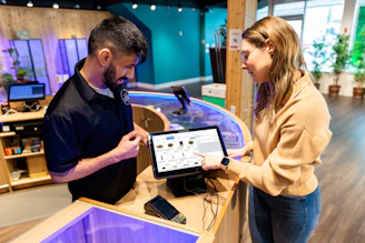 a man and a woman looking at a tablet