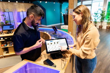 a man and a woman looking at a tablet