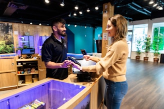 a man and a woman standing in front of a fish tank