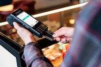 a person holding a cell phone in their hand