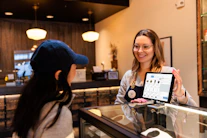 a woman showing a tablet to another woman