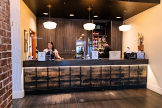 a couple of people that are behind a counter