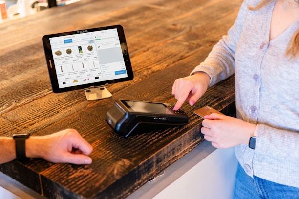 a woman is paying for her cell phone at the cash register