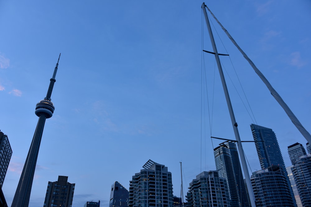 a view of a city skyline with a sailboat in the foreground