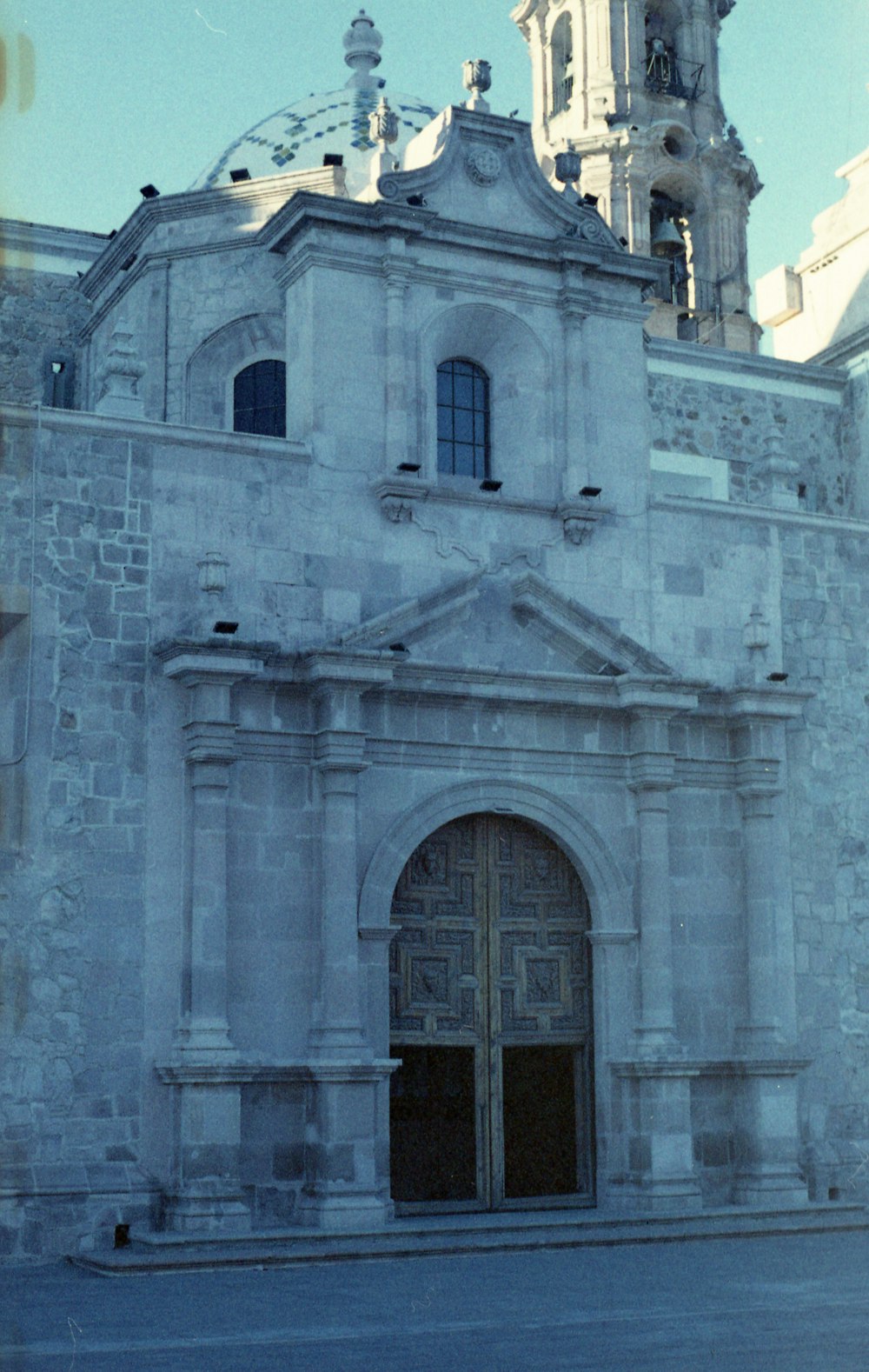 an old church with a clock tower in the background