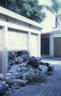 a pile of trash sitting in front of a garage