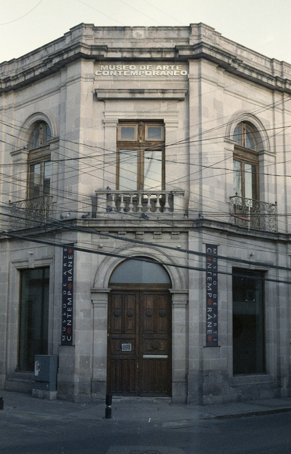 an old building with a wooden door on a street corner