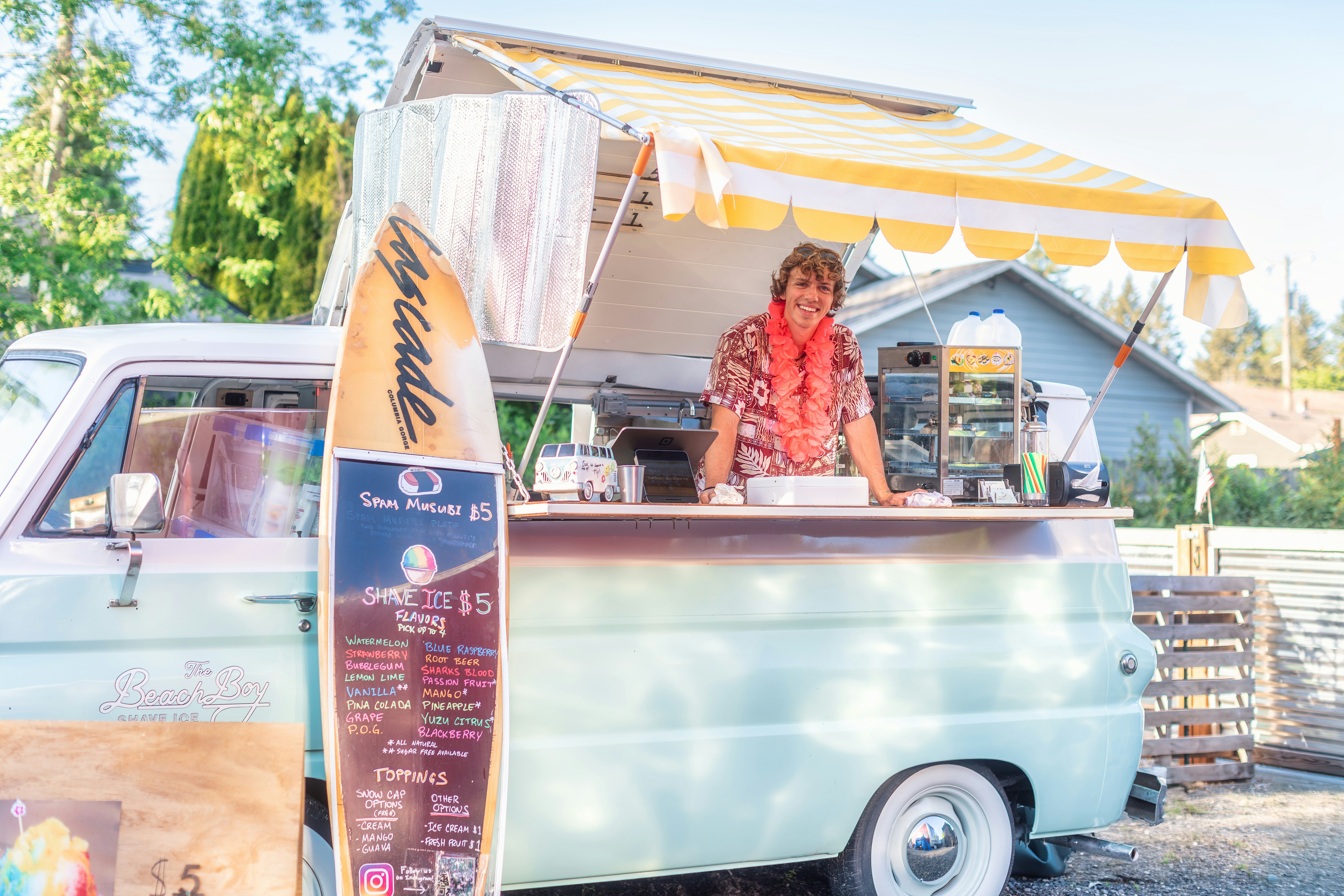 A vintage shave ice food truck with a surfboard menu — food trucks and counter spots are the best places to eat in Oahu