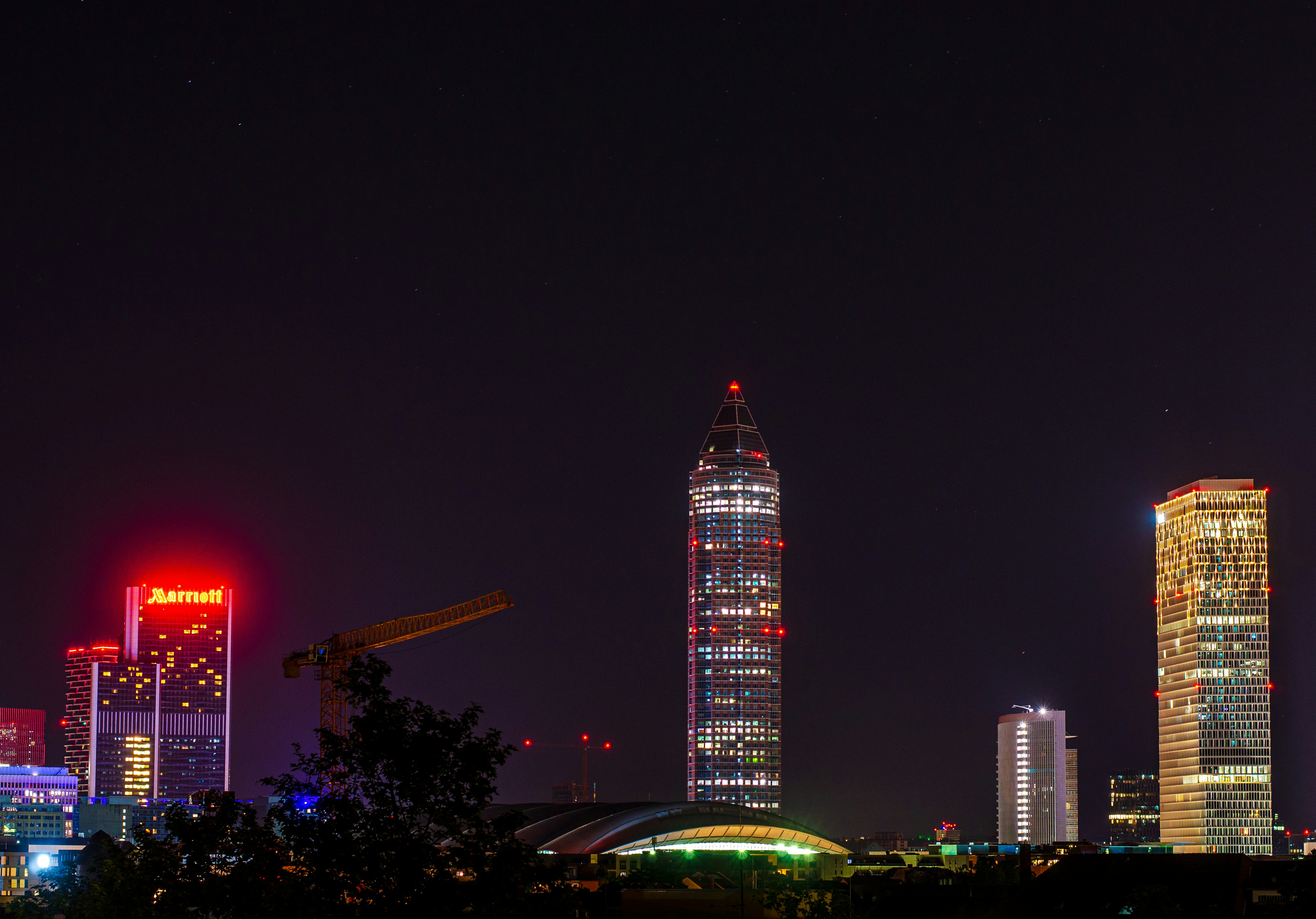 a city skyline at night with skyscrapers lit up