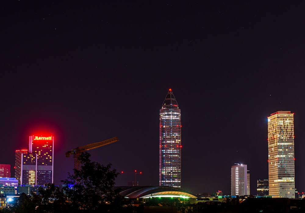 a city skyline at night with skyscrapers lit up