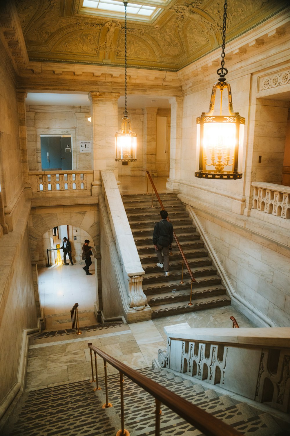 a man walking up a flight of stairs in a building