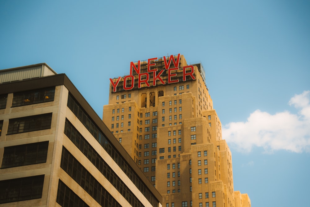 a tall building with a neon sign on top of it