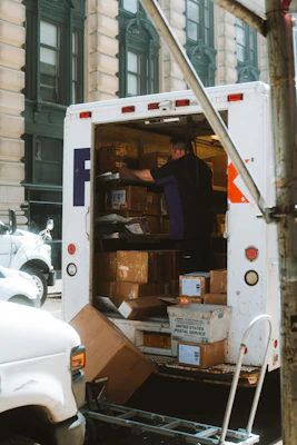 a man loading boxes into the back of a moving truck