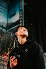 a man standing in front of a tall building