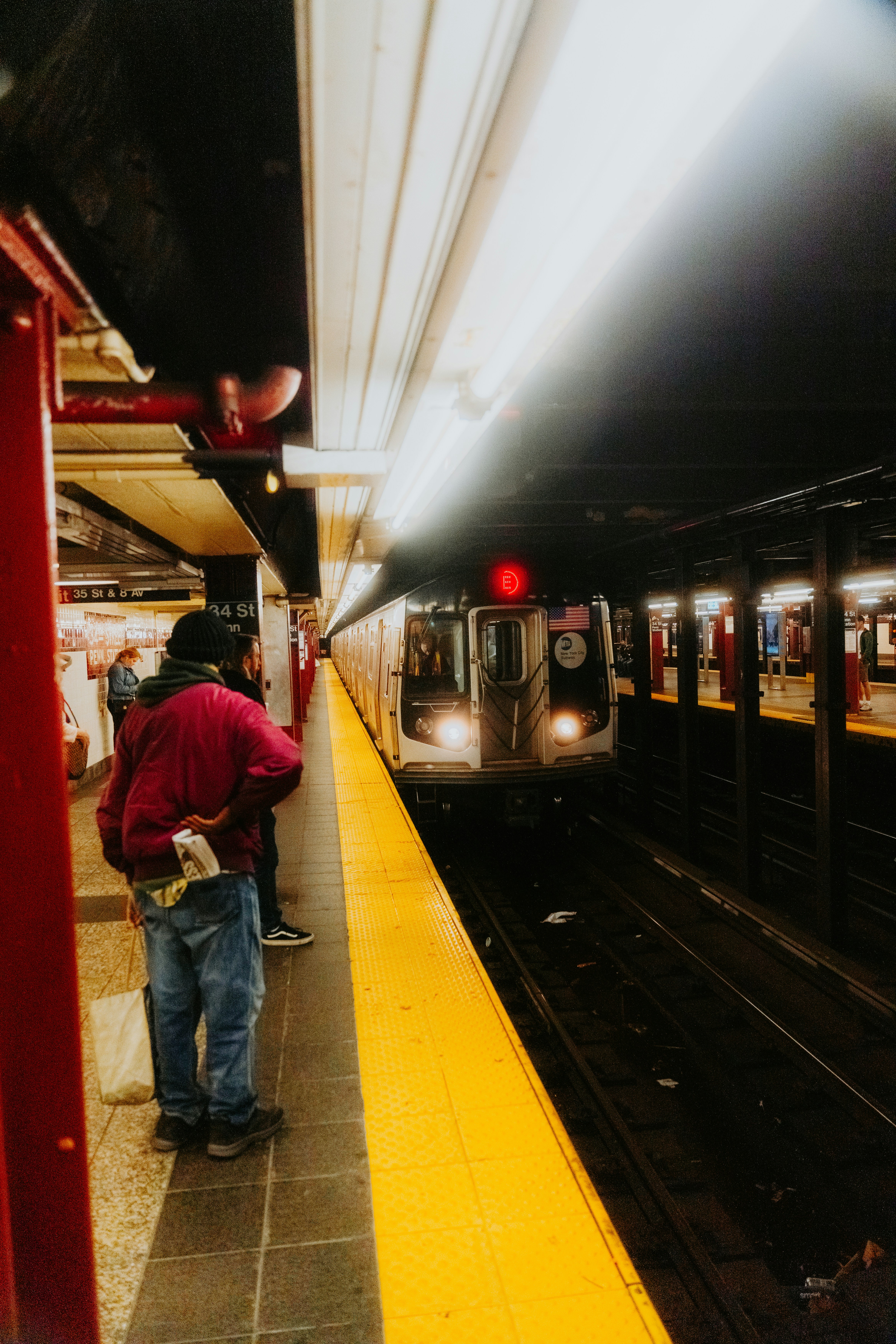 A subway train pulling into a train station photo – Free Woman Image on ...