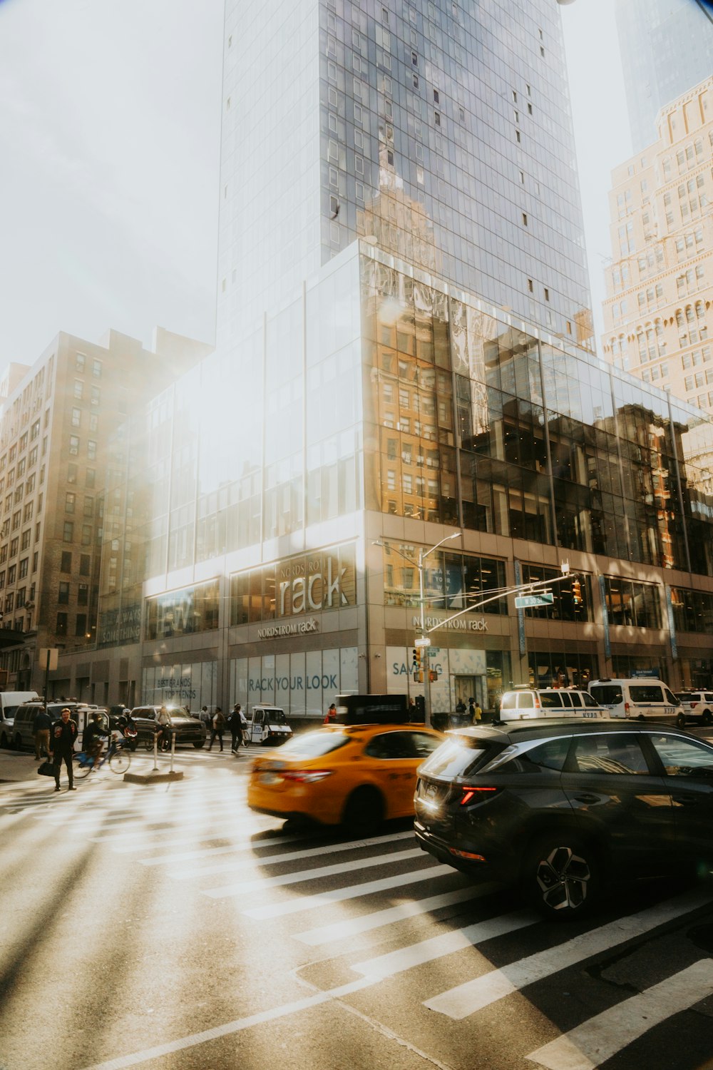 a city street filled with traffic next to tall buildings