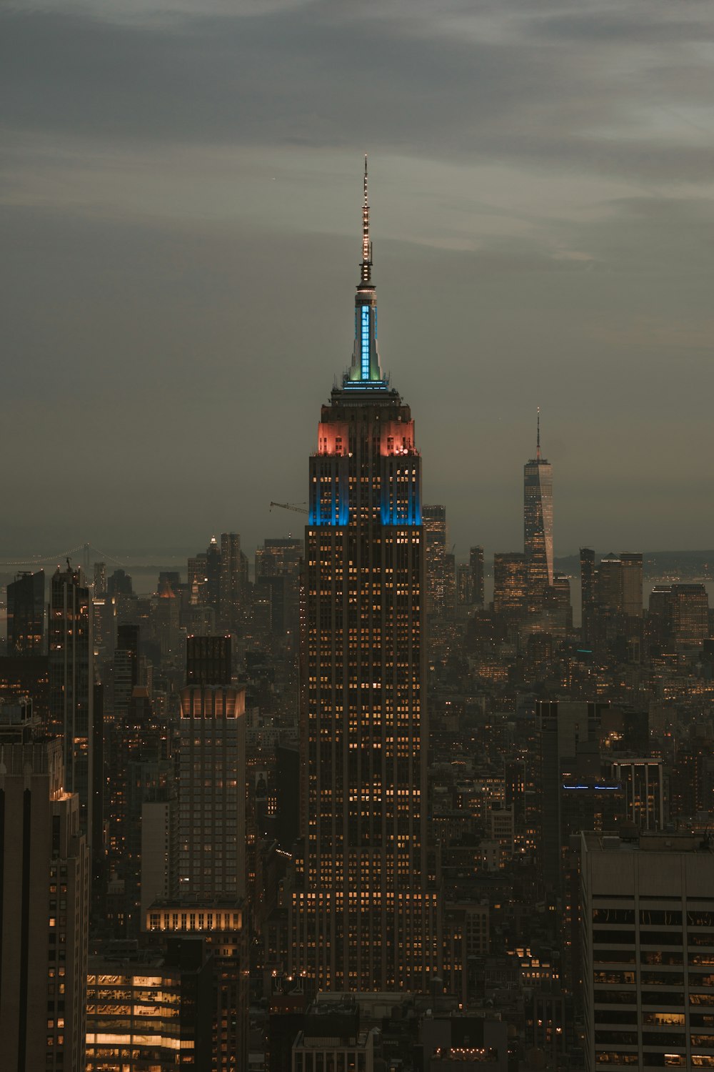 a view of the empire building lit up in blue and red