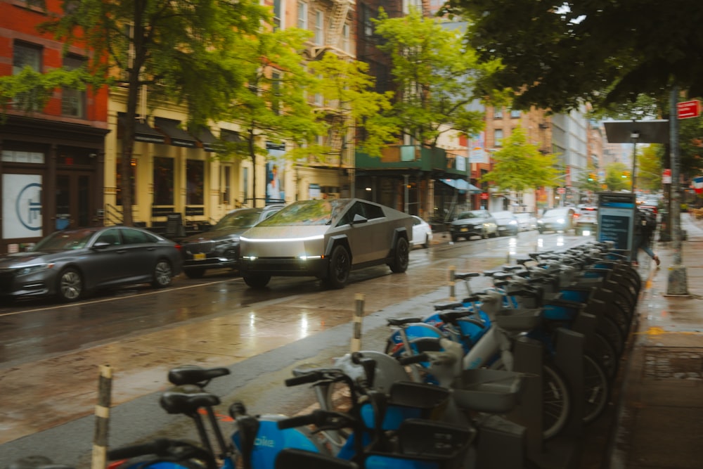 a row of parked bikes sitting next to a street