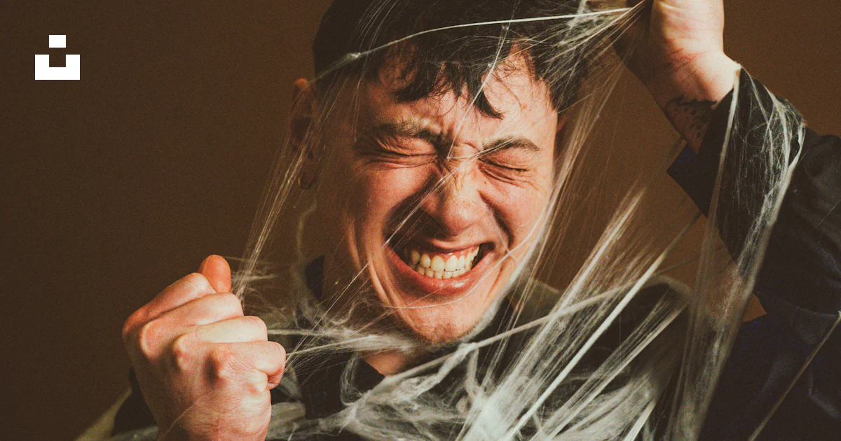 A man holding a string wrapped around his head photo – Free Portrait ...