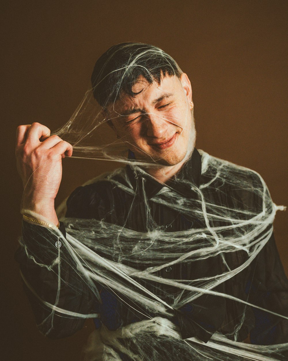 a man with a spider web around his neck