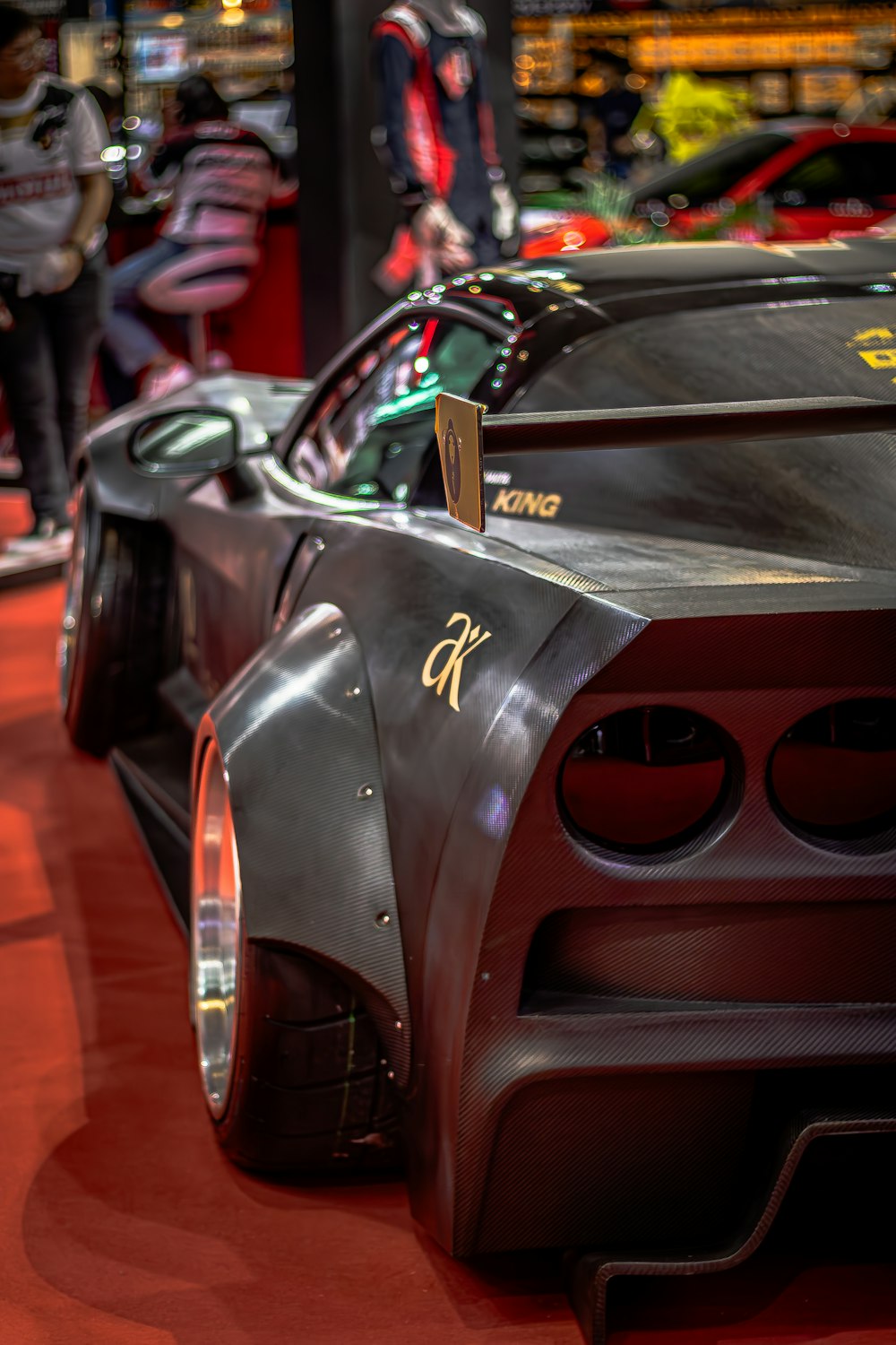 a close up of a sports car on a red carpet