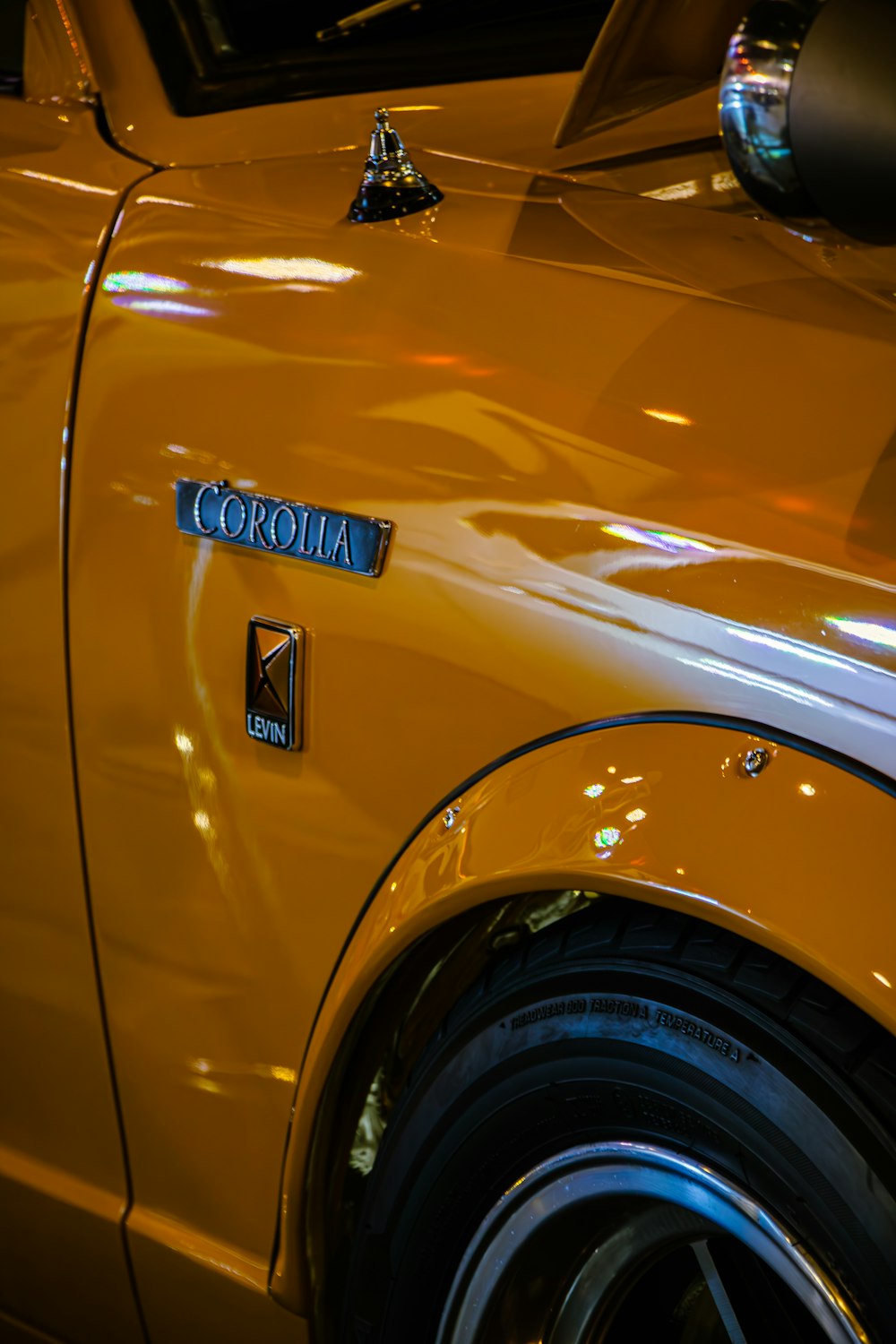 a close up of the emblem on a yellow car