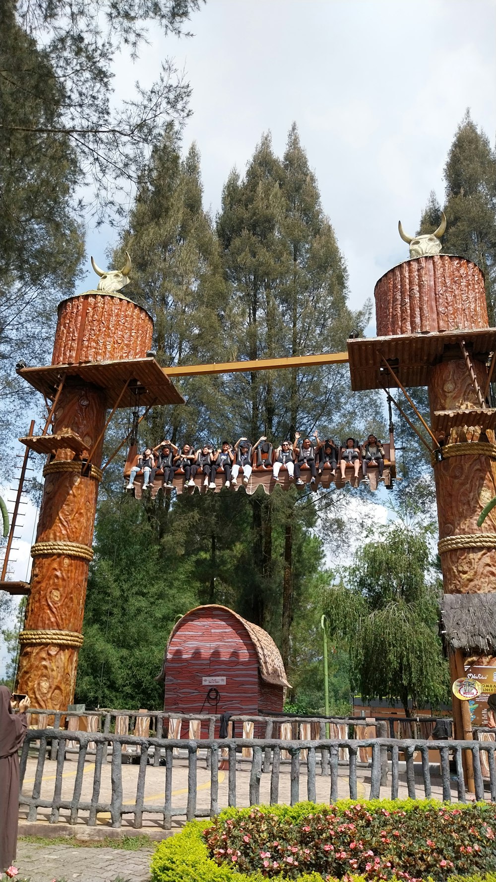 a group of people hanging from a wooden structure
