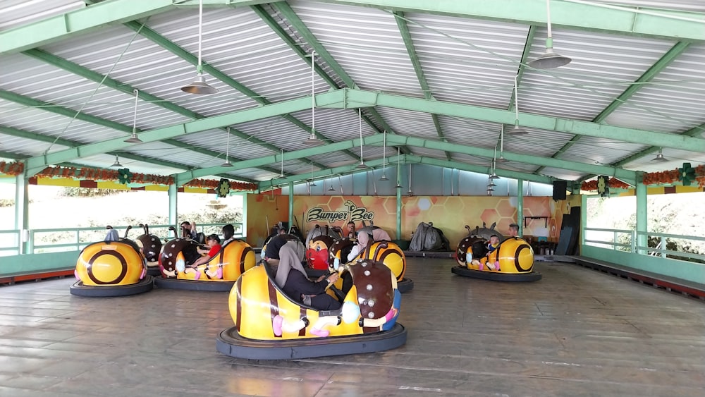 a group of people riding bumper cars in a building