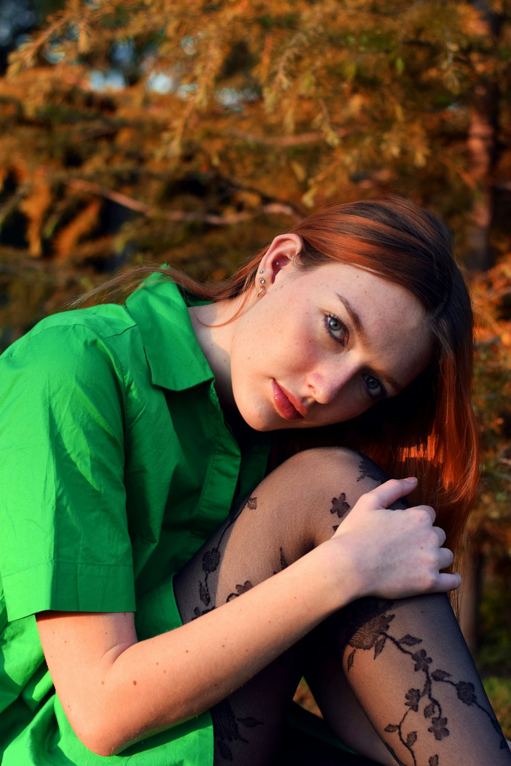 a woman with a green shirt and black stockings